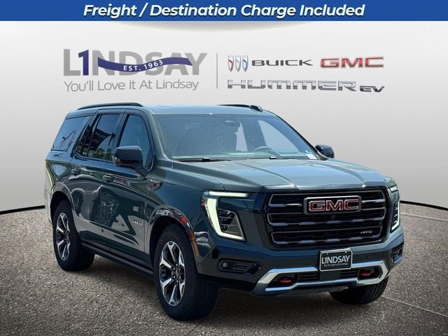 2026 GMC Yukon AT4 Ultimate in Midnight Pine — front three-quarter view